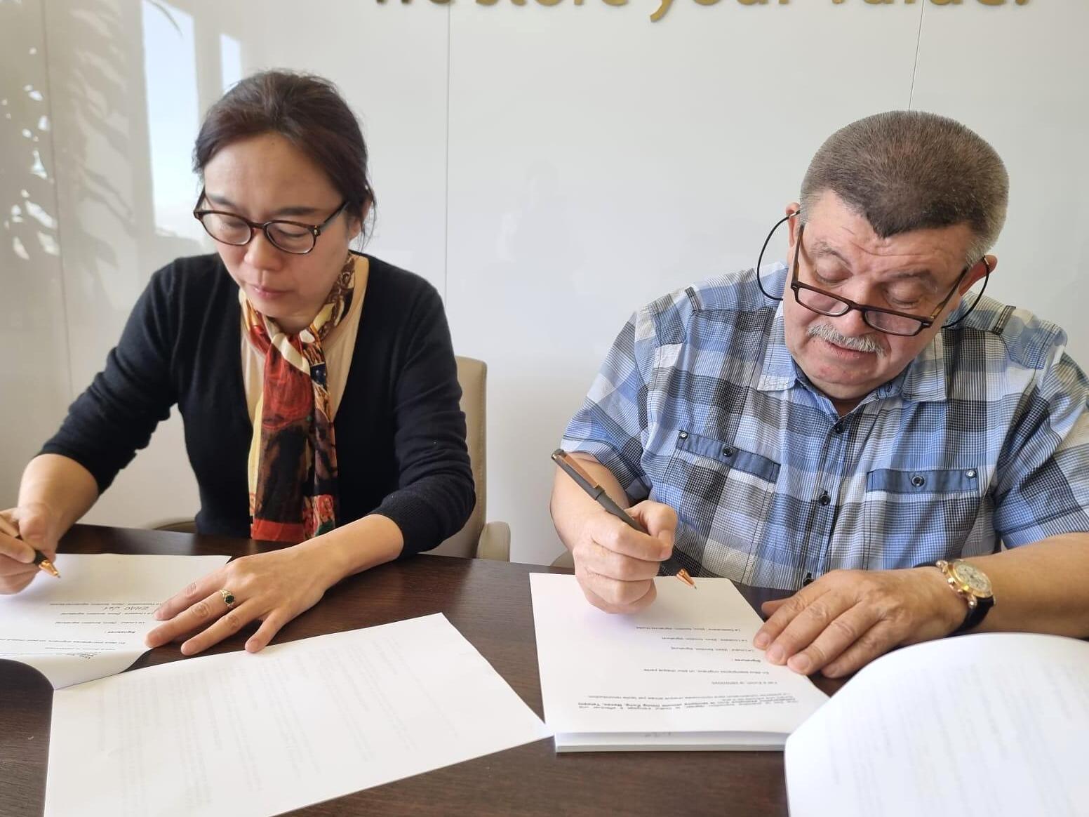 Andranik Ghazarian — Zhao Lei reviewing and signing project documents.