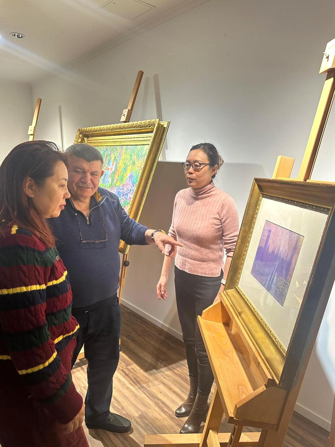 Andranik Ghazarian — Andranik Ghazarian with visiting colleagues before a work placed on the easel.